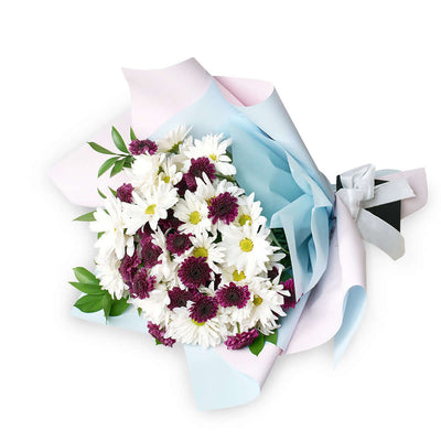 First Whisper of Spring Daisy Bouquet. White and purple daisies gathered with ruscus in a floral wrap and tied with a designer ribbon. Flower Gifts from Monthly Sommelier USA - Same Day USA Delivery.