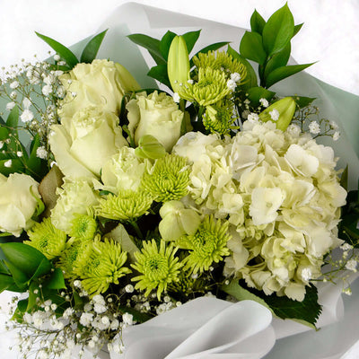 Blossoming Sunrise Mixed bouquet. Lilies, roses, hydrangea, and daisies along with baby's breath and ruscus in a floral wrap with designer ribbon. Mixed Floral Gifts from Monthly Sommelier USA - Same Day USA Delivery.