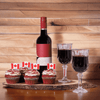 "Oh, Canada!" Cupcakes & Wine Gift Basket features Wine, (2) Macian Wine Glass, Cupcakes, & an Oval Live Edge Cutting Board.