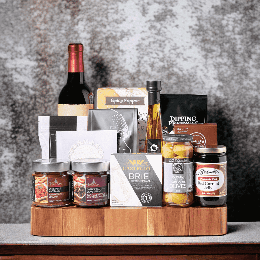 "Plenty of Snacks" Gourmet Gift Basket with Wine Set features crackers, cheese, serving board, pretzels, wine, olives and spreads.