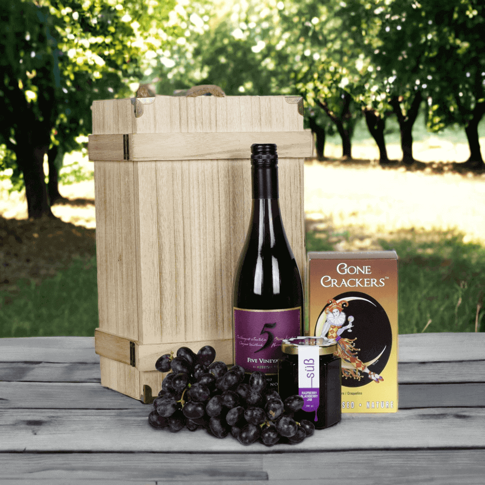 The Superb Wine & Jam Gift from Monthly Sommelier features a bottle of wine, crackers, grapes, and jam.