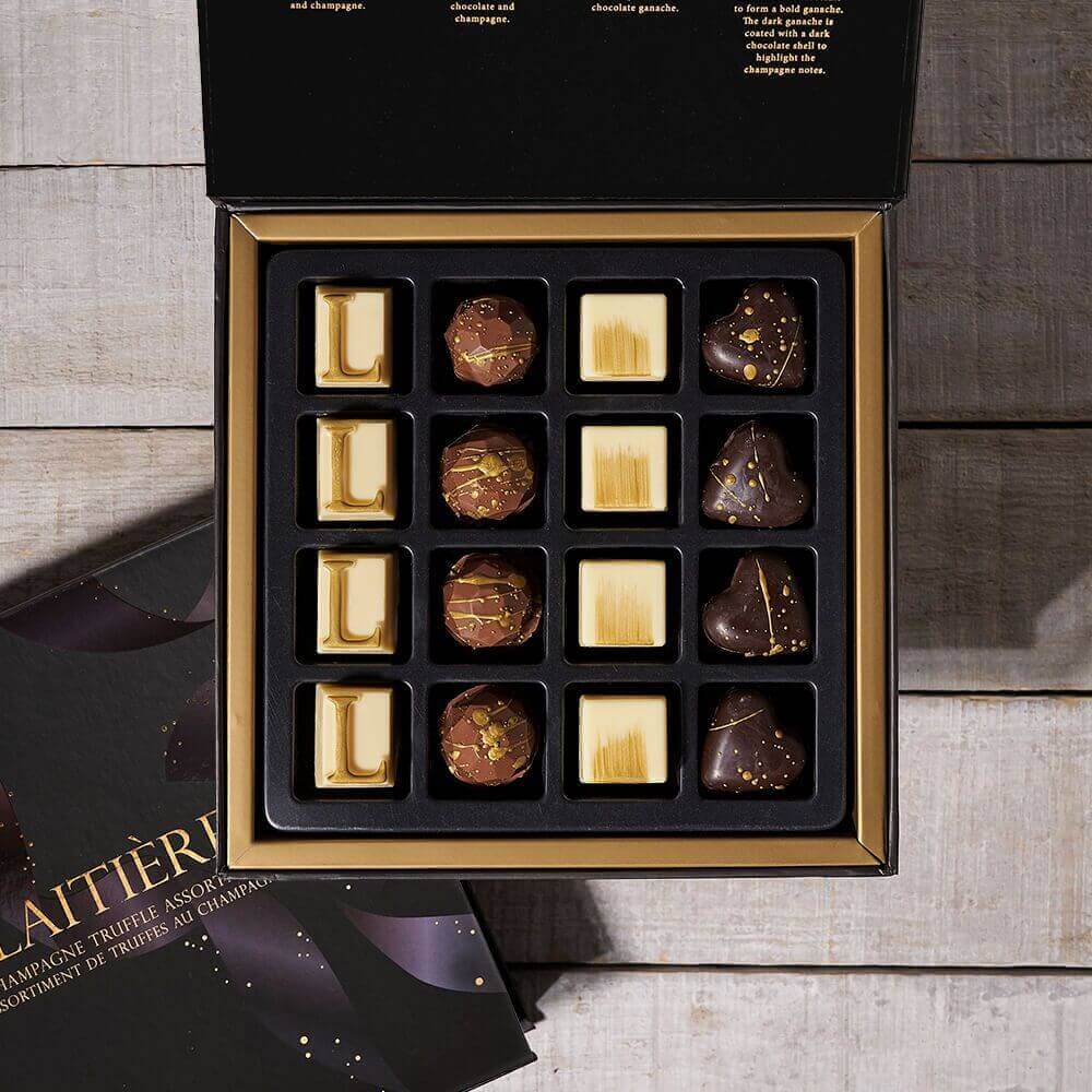 This gourmet gift includes a bottle of sparkling wine, two champagne flutes, and a box of champagne-inspired chocolate truffles.