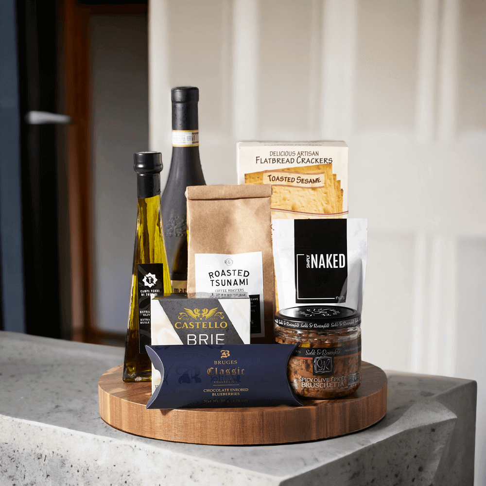 The Grand Gourmet Wine Gift Basket from Monthly Sommelier is a special gift for someone special, loaded with deliciously luxurious snacks and delicacies. With gourmet brie cheese and crackers, spicy olive bruschetta, rich olive oil, sea salt almonds, delicious chocolate covered blueberries, and coffee, this gift basket is a delightful treat.