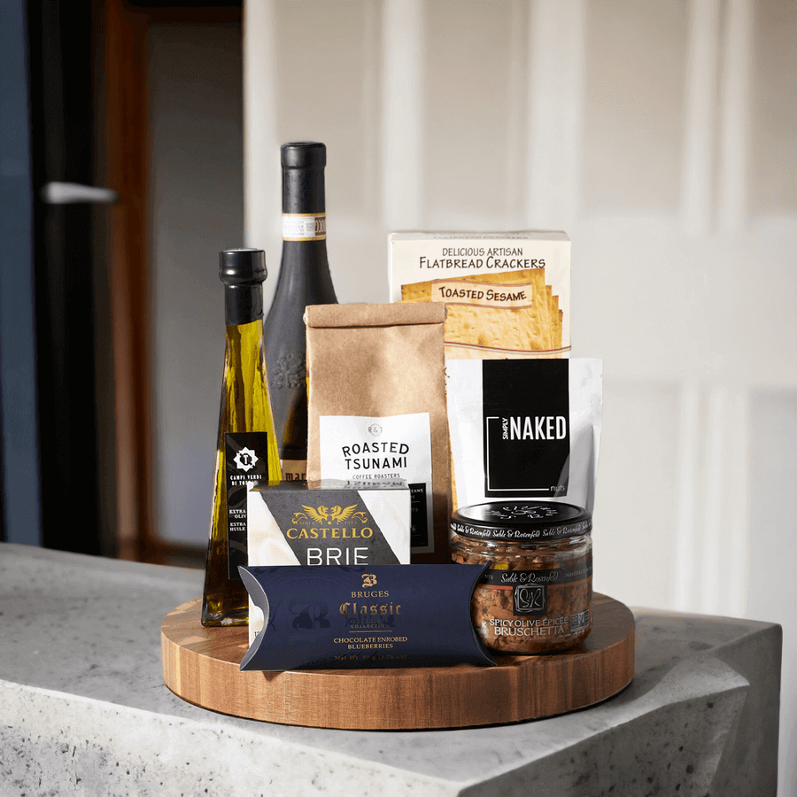 The Grand Gourmet Wine Gift Basket from Monthly Sommelier is a special gift for someone special, loaded with deliciously luxurious snacks and delicacies. With gourmet brie cheese and crackers, spicy olive bruschetta, rich olive oil, sea salt almonds, delicious chocolate covered blueberries, and coffee, this gift basket is a delightful treat.