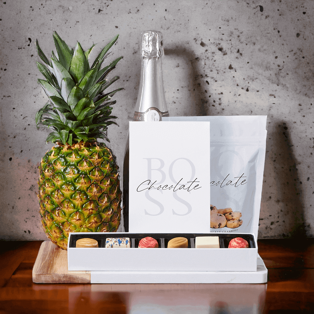 The Grand Sparkling Wine & Pineapple Gift Set, we intend to make the moment even more special for your loved ones. The gift set features attractive gifts like a beautifully fresh pineapple, milk chocolate caramels, white chocolate cranberry shortbread cookies, white chocolate truffles, and a marble & wood serving board.