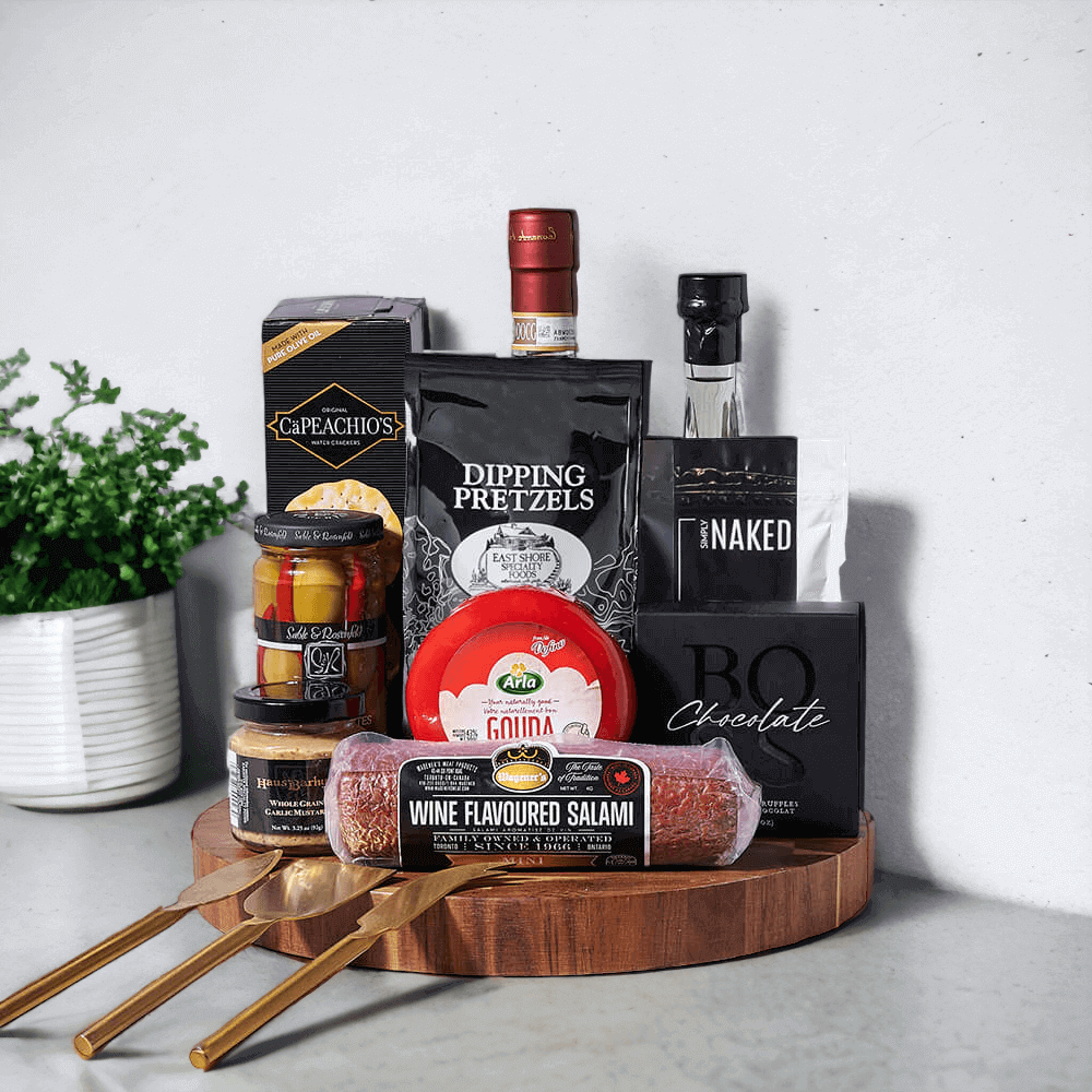 Tuscan Leonardo Red Wine & Cheese Board, send a gourmet gift that’s sure to please. Included in this gift basket is a bottle of Leonardo Chianti Fiasco, extra virgin olive oil, chocolate truffles, whole grain garlic mustard, dipping pretzels, gouda cheese, savoury wine-flavoured salami, tipsy fiery olives, crackers, pistachios, three charcuterie knives, and a sturdy acacia wood cutting board.